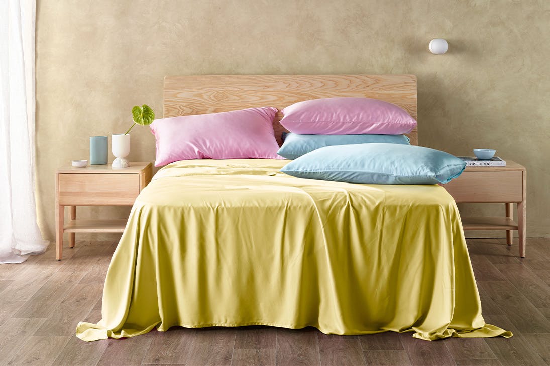 a bed with colourful sheets on it